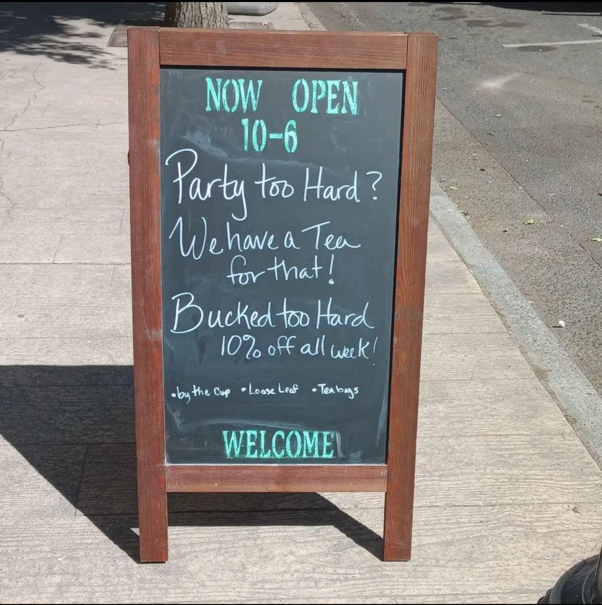 A chalkboard sign that says:

“Now open 6-10. Party too hard? We have a tea for that Bucked too hard 10% off all week”