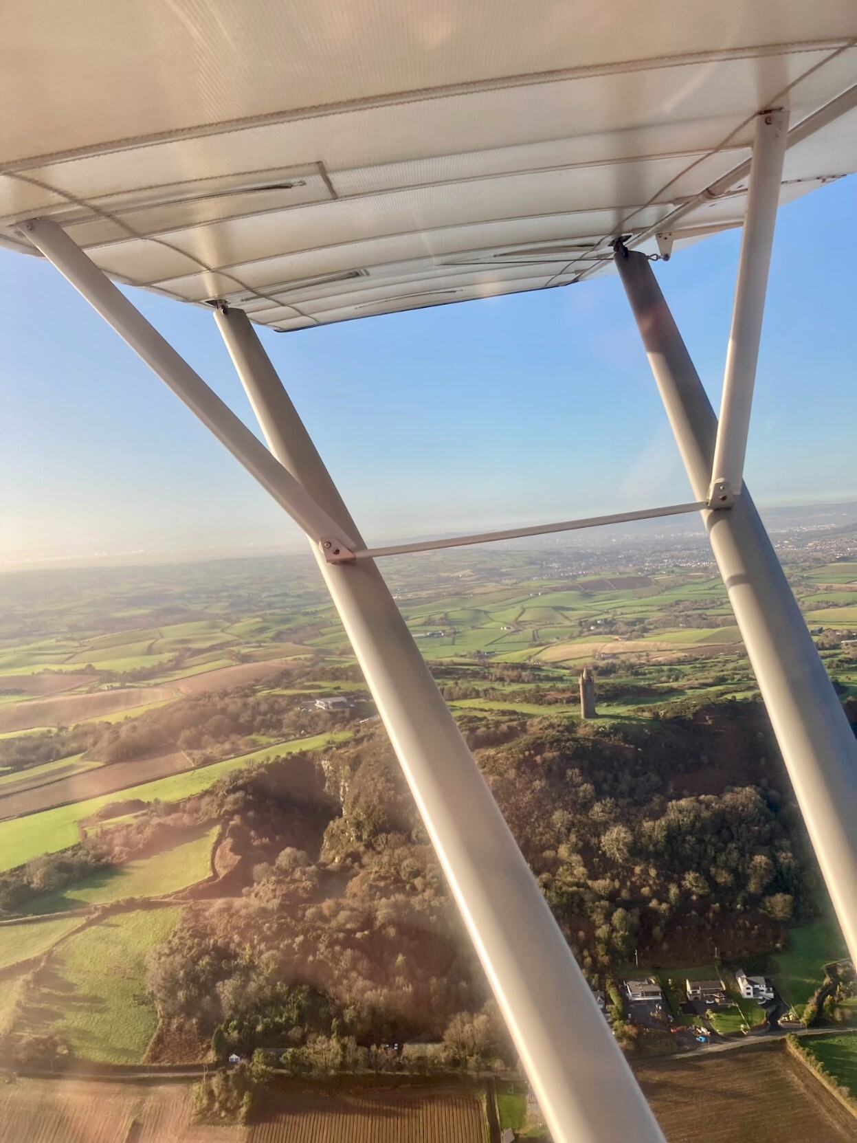 Scrabo tower, framed by the wing structs of a light aircraft