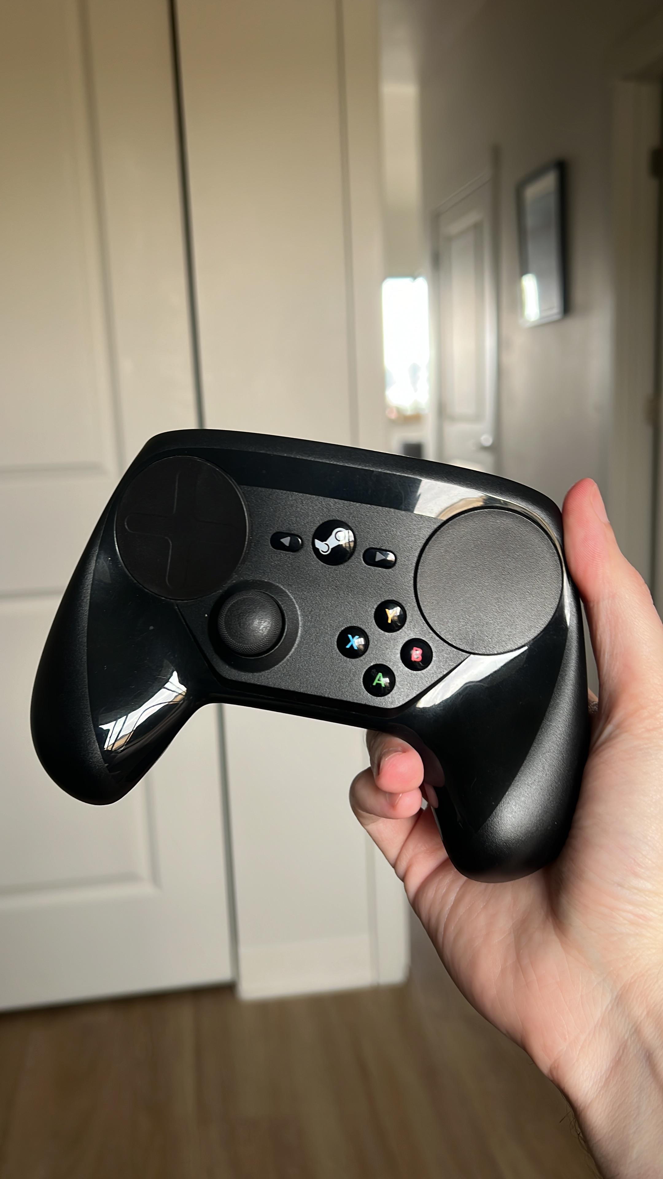A steam controller held at arms length