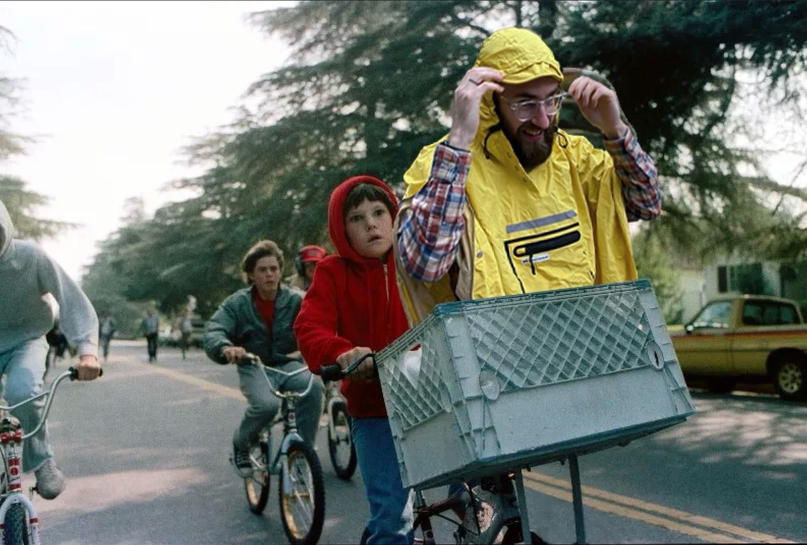 A photoshopped scene from the movie E.T. where instead of ET being in a basket on the front of a bike, it’s me in my poncho.